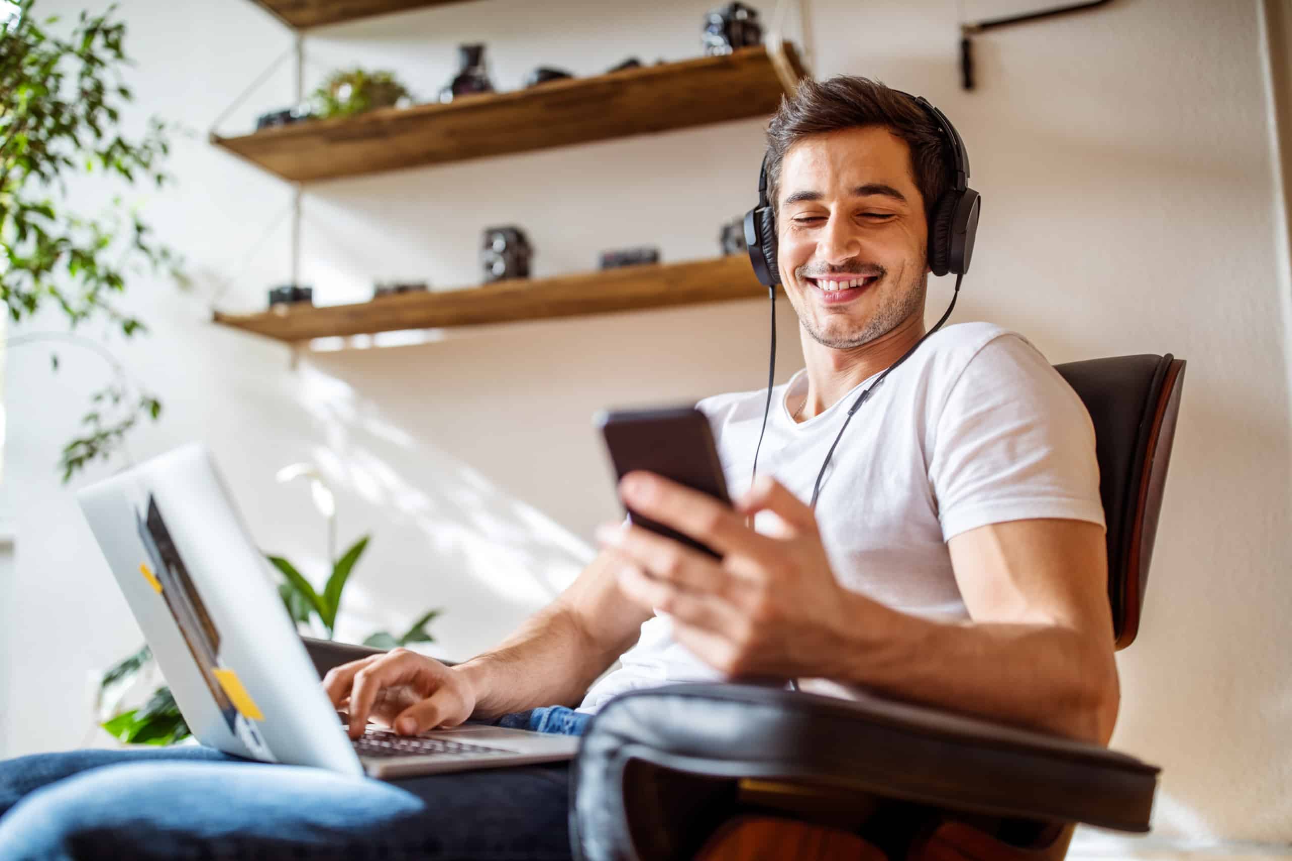 Clear Channel Outdoor - man listening to music while shopping online