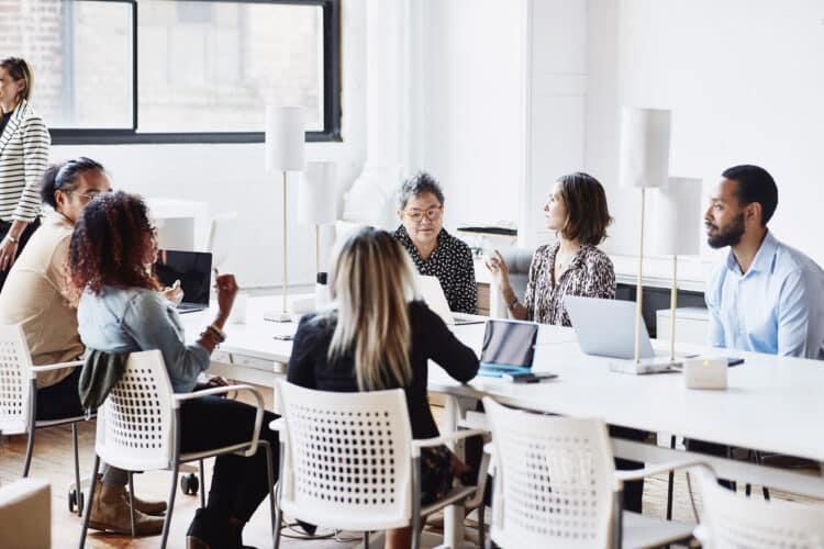 business meeting at a large table, coworking office at Clear Channel Outdoor