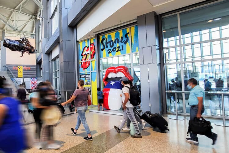 Clear Channel Outdoor JFK walking through a terminal seeing an experiential install for the rolling stones 2021 tour