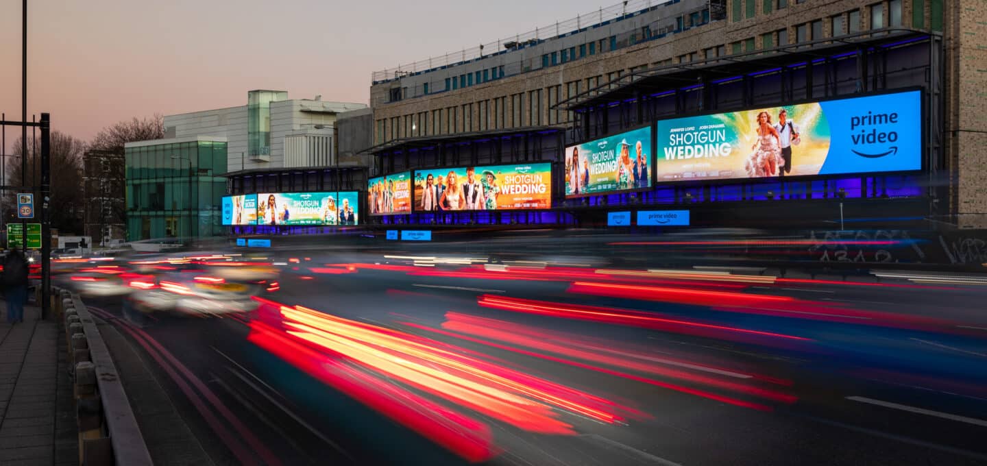 Clear Channel Outdoor blurred headlights on a highway flanked by Amazon Prime Storm Cromination