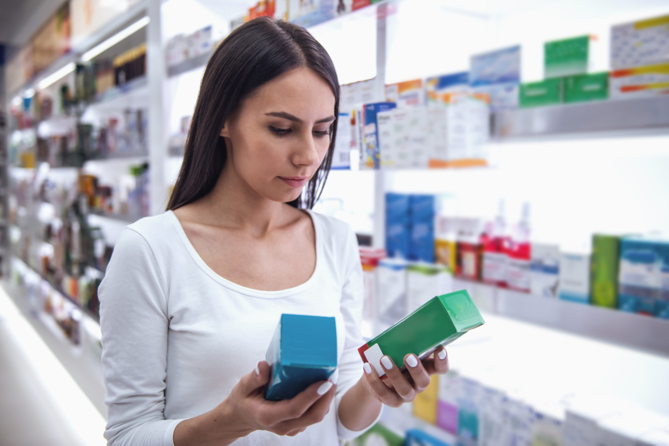 Woman is choosing a medication at the pharmacy